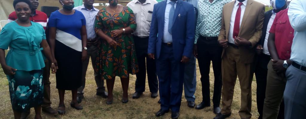 Members of the District Cooperate Team posing with the Outgoing CAO Mr. Oloya Stephen Gunya